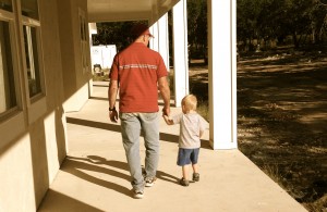 Eli walks on the front porch with Papa Ron